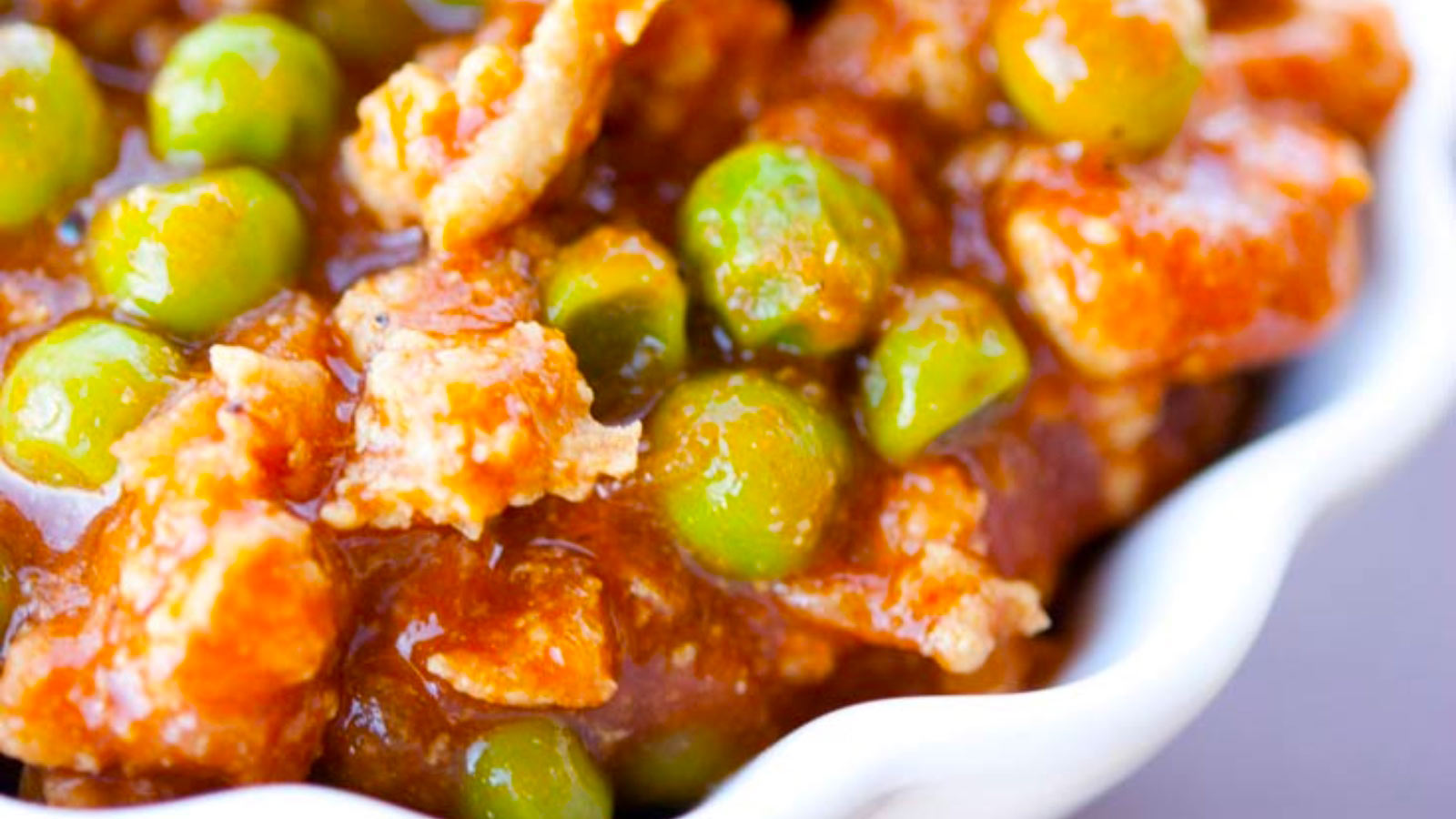 Closeup of a white bowl full of curry turkey chili.
