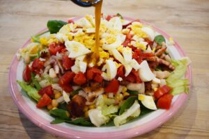 Pouring dressing over this High-Protein Dense Bean Salad.