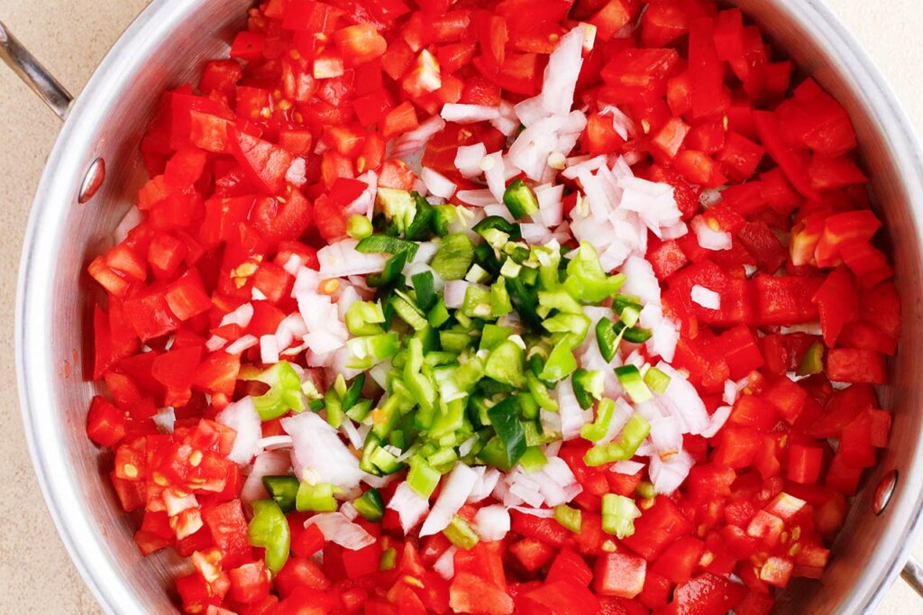 Simmering Rotel ingredients in a pan.