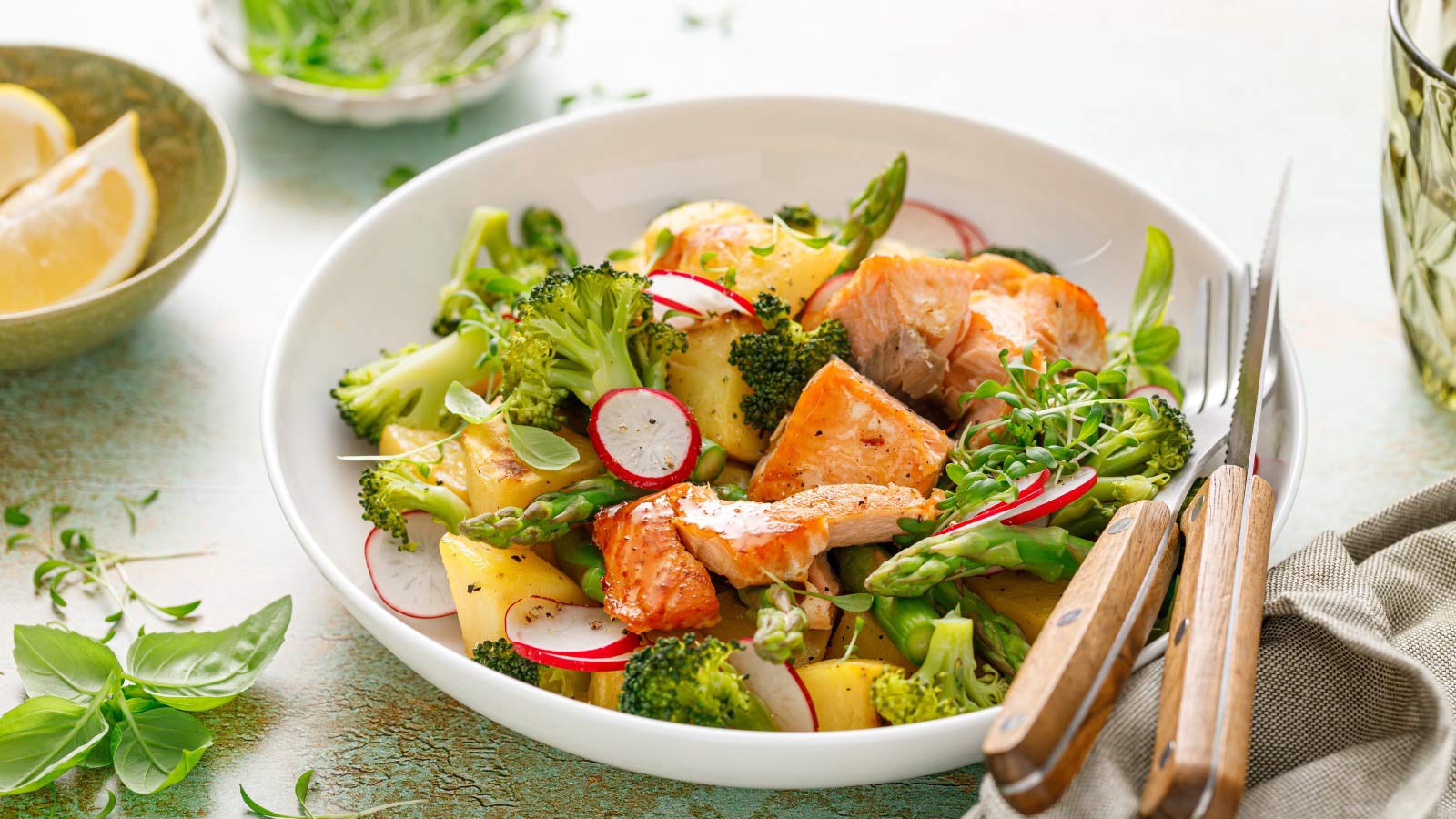 Salmon and potato salad with asparagus, broccoli and radish