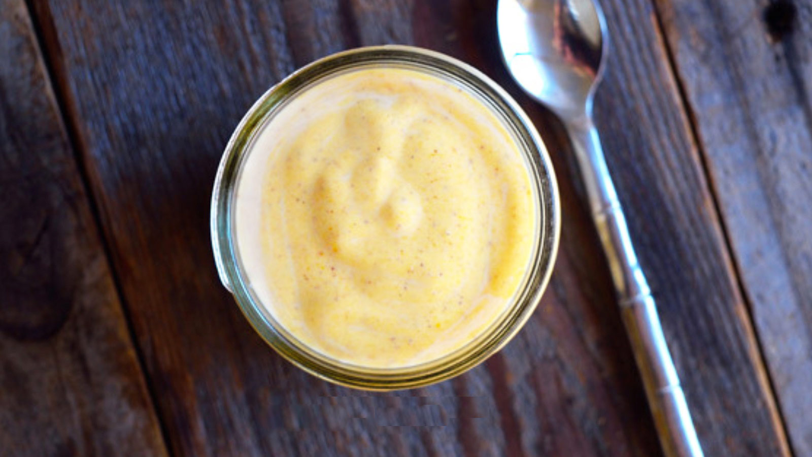 Overhead focus. An open, glass jar filled with Pumpkin Spice Yogurt Recipe.
