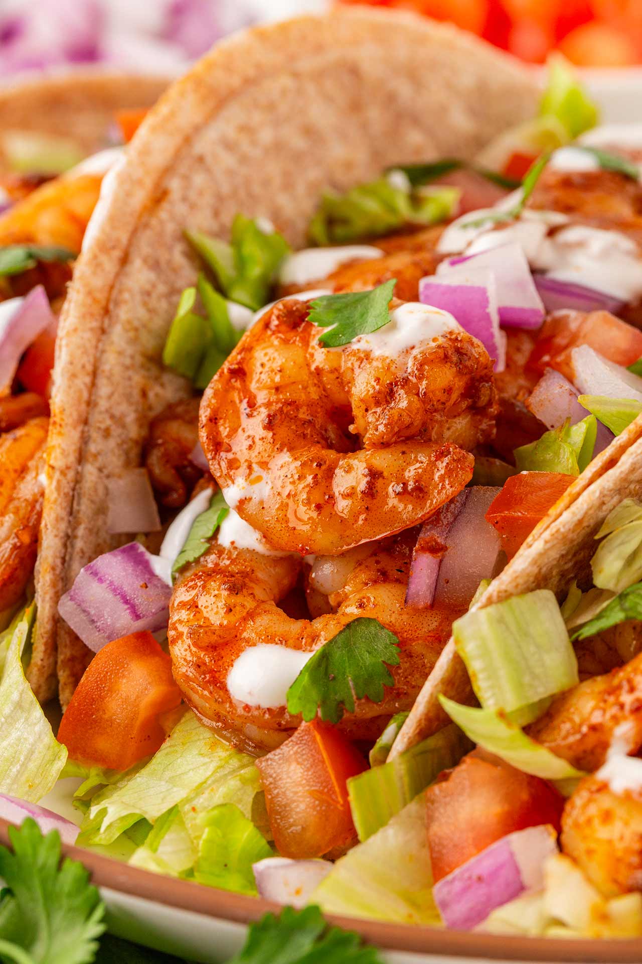 Closeup of a shrimp taco on a platter.