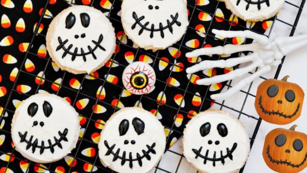 An overhead view of Jack Skellington cookies laying on a black, wire, cooling rack.