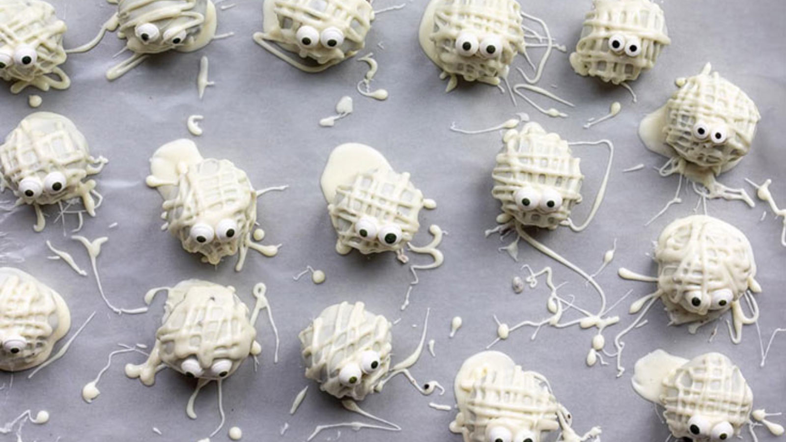 Chocolate truffle mummies cooling on parchment paper.