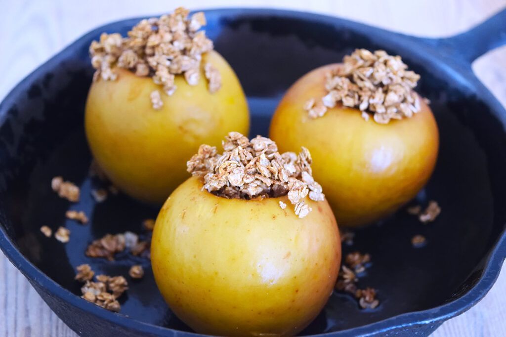 Three Baked Breakfast Apples in a skillet.