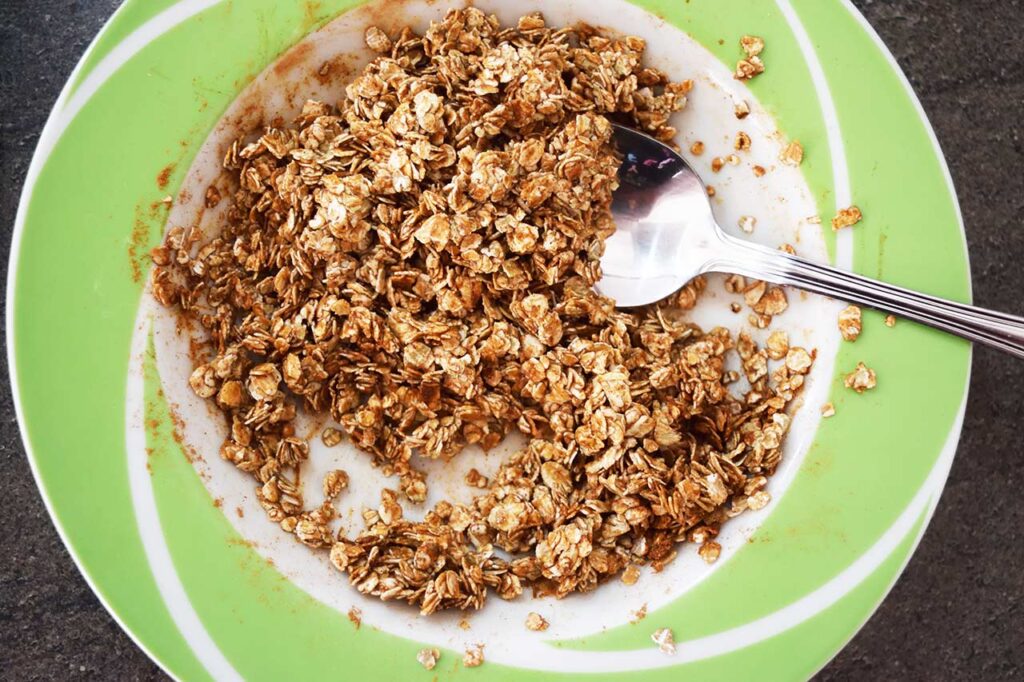 Moistened oats in a mixing bowl.