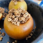 Front view of baked apple in a skillet.