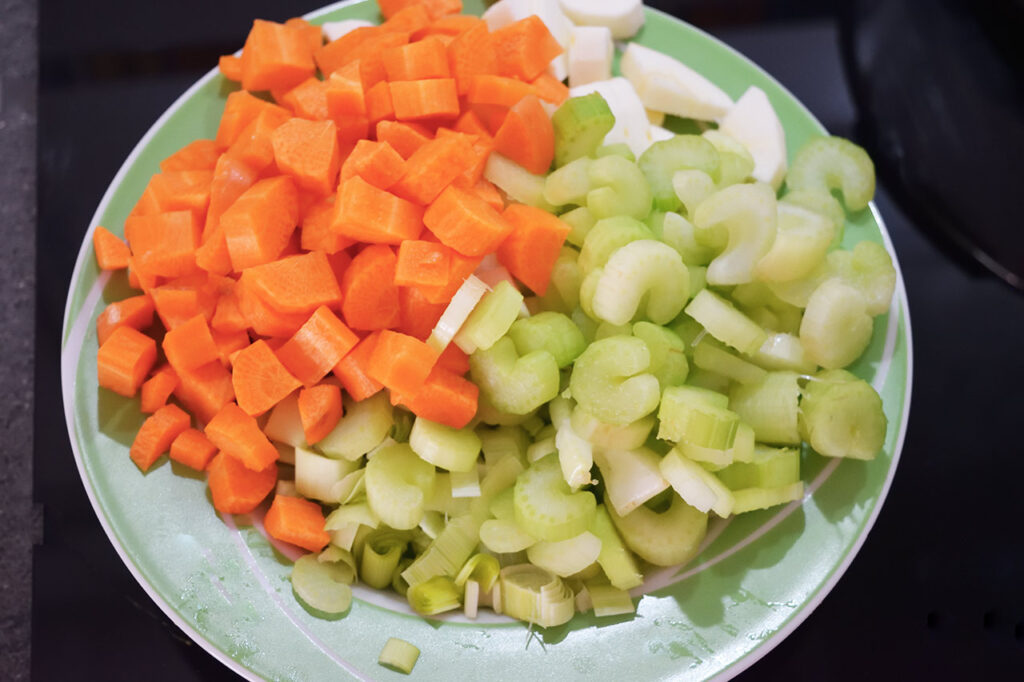 Cut Butternut Squash Soup vegetables on a plate.