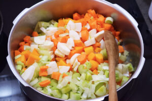 Butternut Squash Soup vegetables added to a pot with oil and onions.