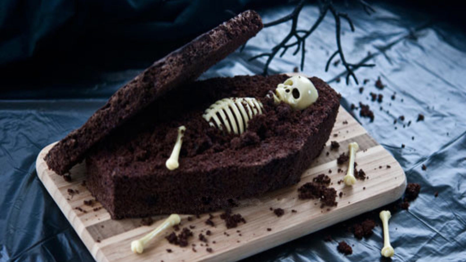 Chocolate Coffin Bread Coffin displayed on a cutting board with a skeleton inside the coffin.