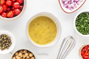Whisked Greek Rice Bowl dressing in a mixing bowl.