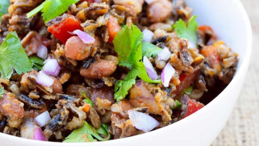 A white bowl filled with Mexican wild rice salad.
