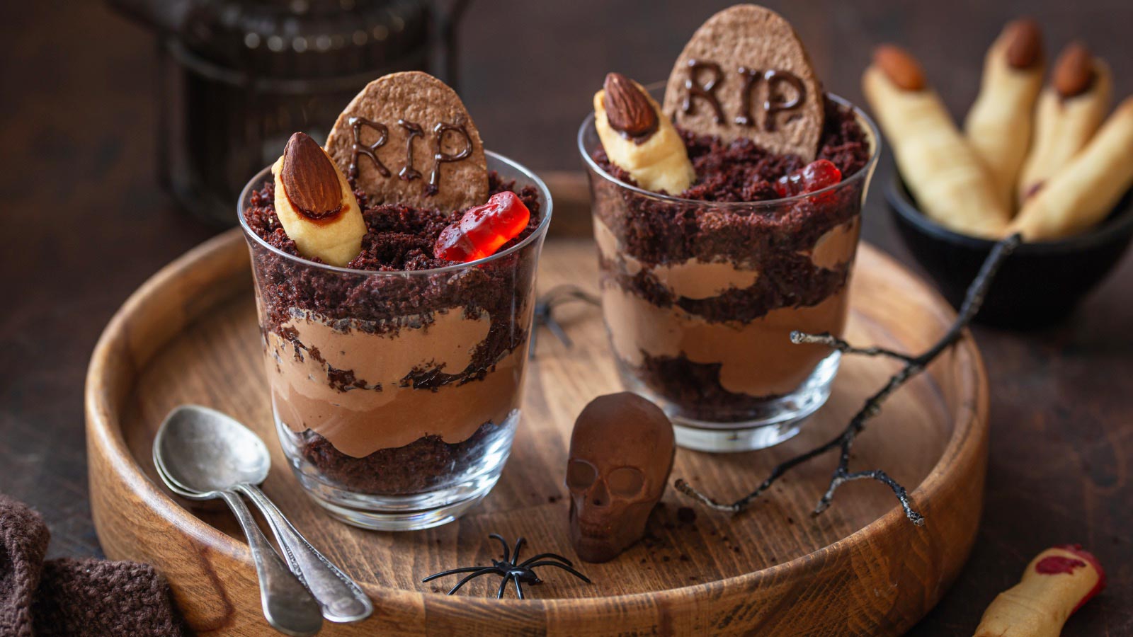 Sweet and funny desserts for Halloween party. Dirt graveyard chocolate cups with Witch Finger cookies and gummy worms
