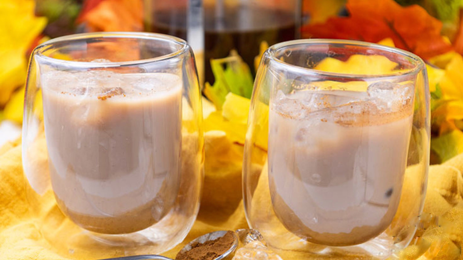 Two small espresso cups filled with Iced Pumpkin Spiced Latte.
