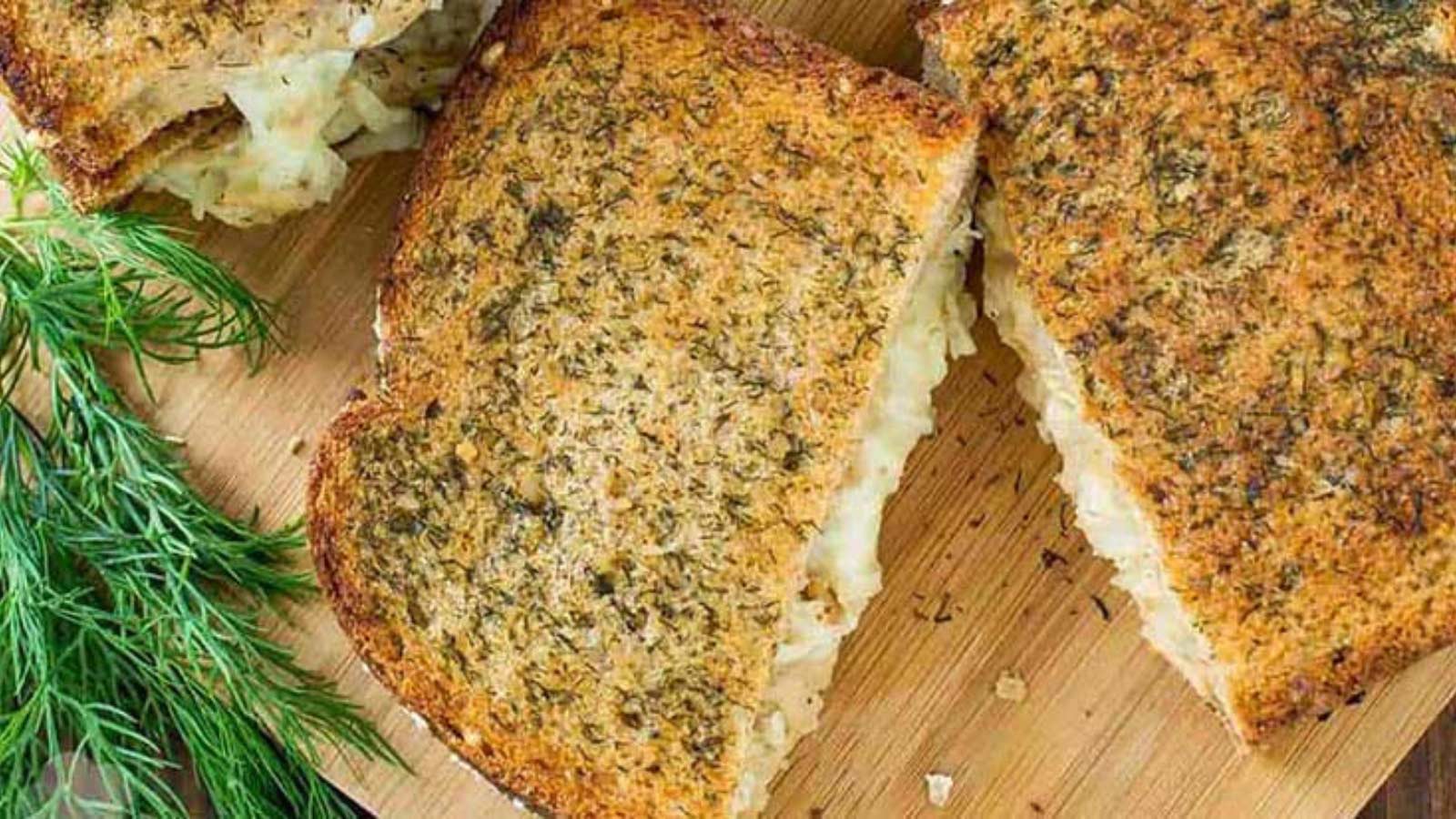 Overhead view looking down onto a cut cut sandwich on a cutting board.