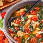 Side view of a bowl of Mediterranean Salmon Soup.