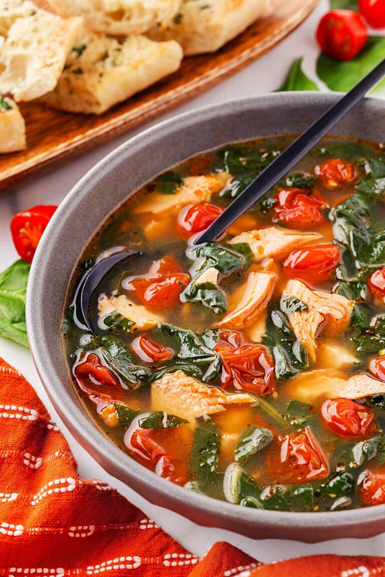 Side view of a bowl of Mediterranean Salmon Soup.