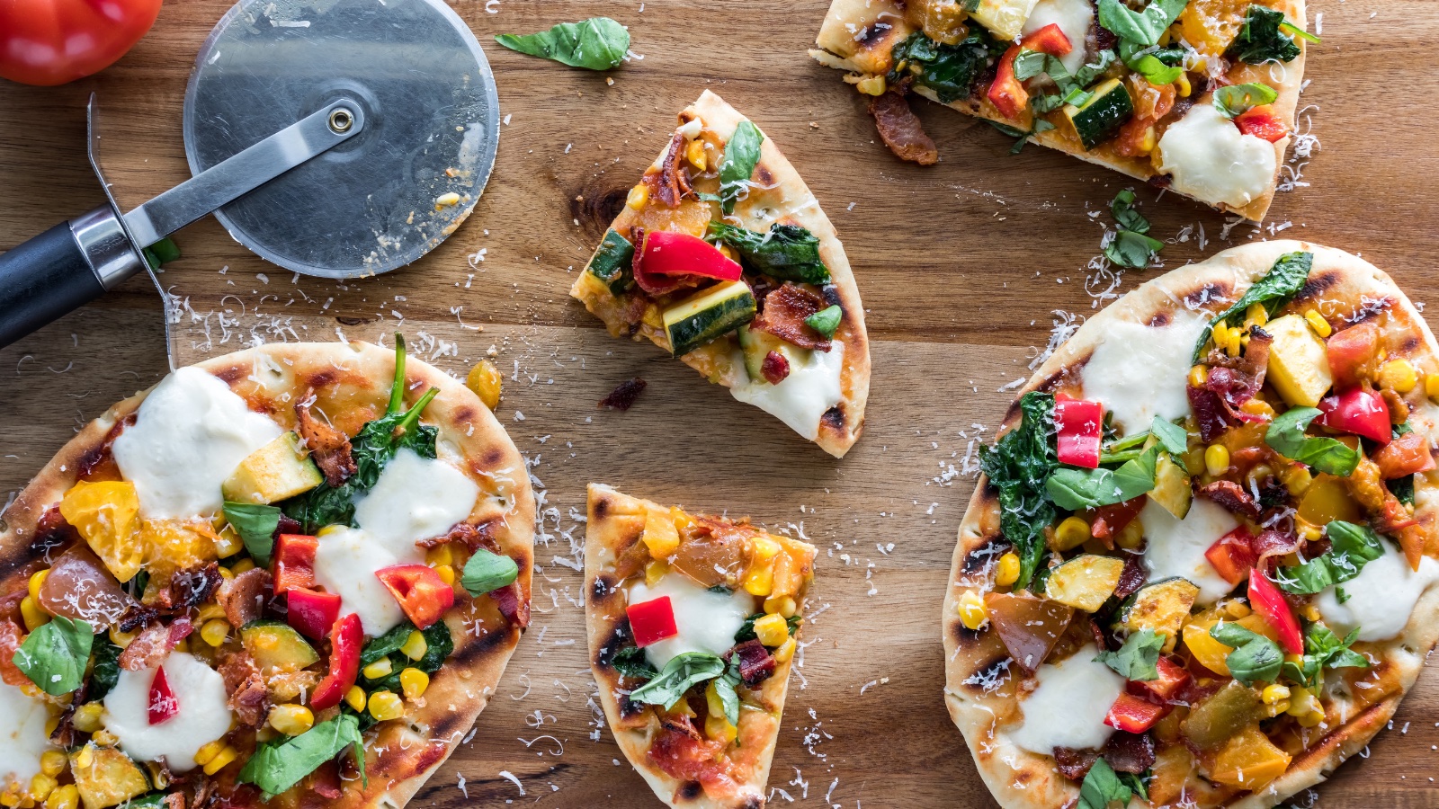 Homemade summer garden pizzas on grilled naan bread.