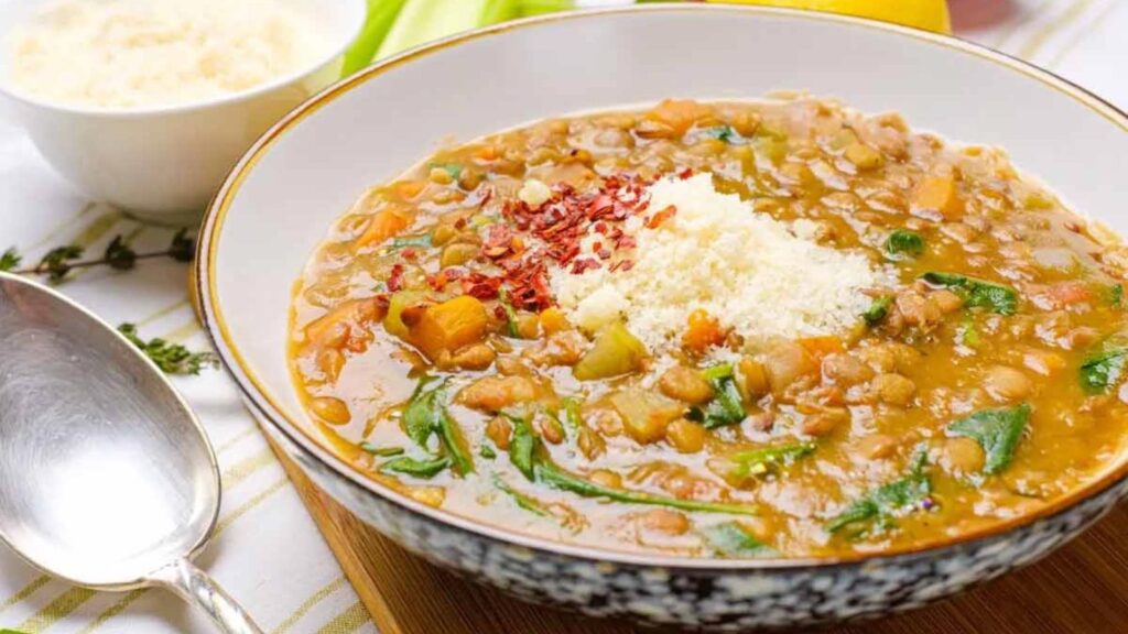A bowl of lentil soup sits on a table.