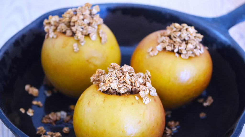 Three Baked Breakfast Apples in a skillet.
