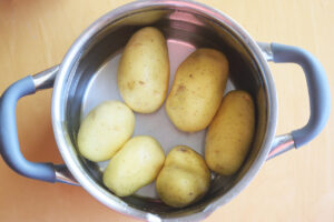 Potatoes in a pot of water.