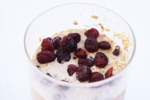Closeup of a glass filled with Cranberry Overnight Oats.