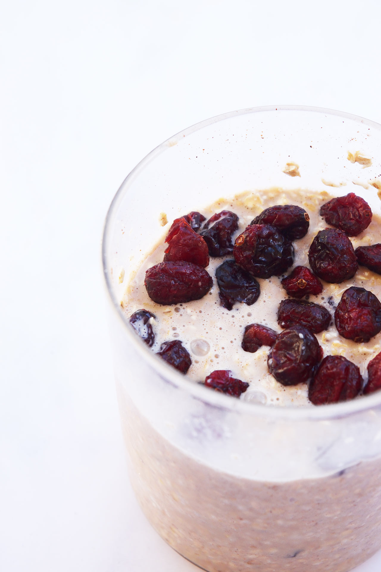 Side view of a glass jar of Cranberry Overnight Oats.