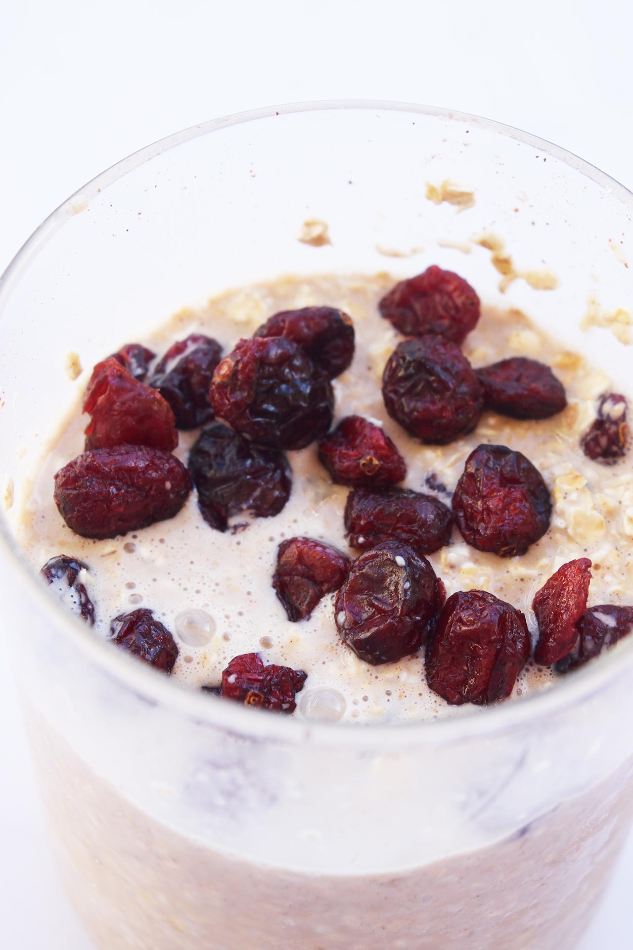 Closeup of a glass jar filled with Cranberry Overnight Oats.
