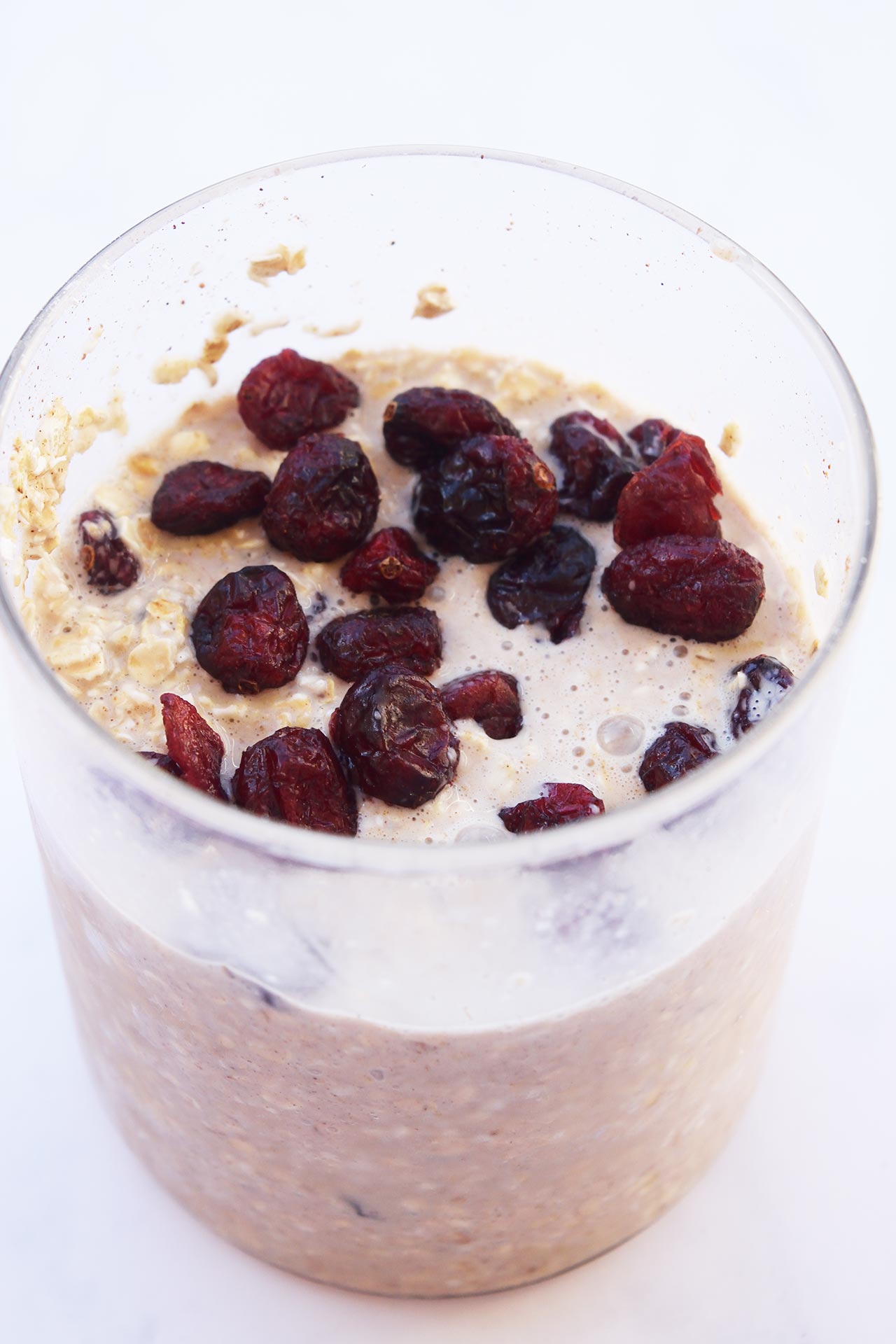 Cranberry Overnight Oats in an open glass jar.