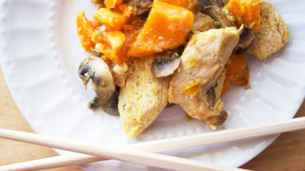 Overhead view of chicken stir fry on a white plate.