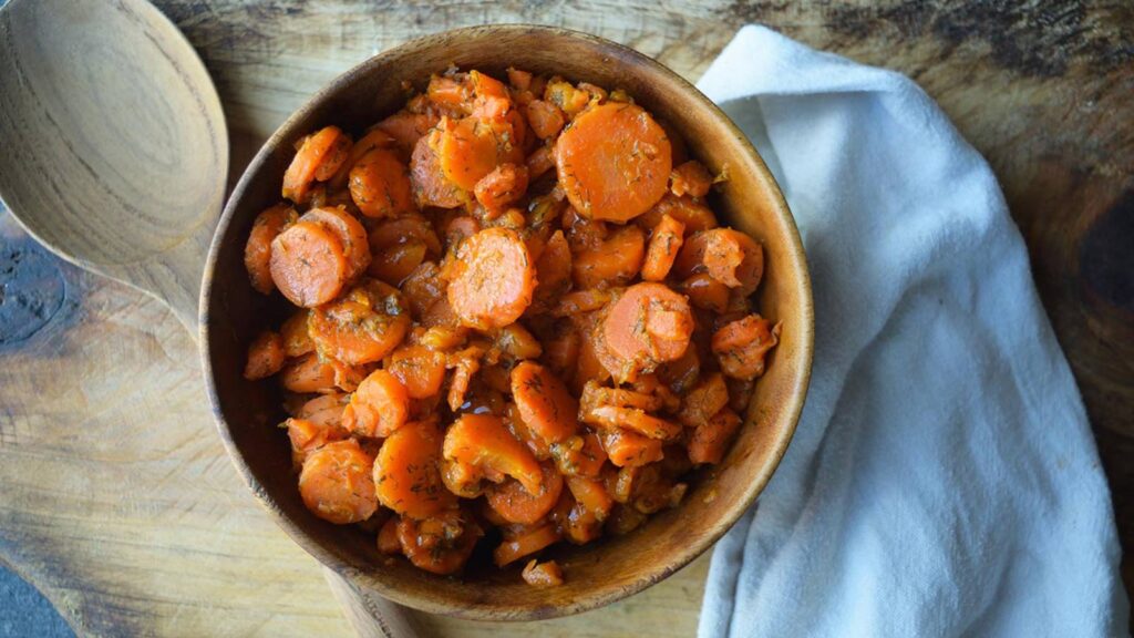 Dill carrots served in a wooden bowl.