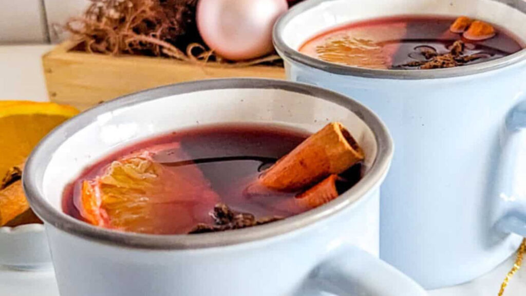 Closeup of two white mugs filled with gluhwein.