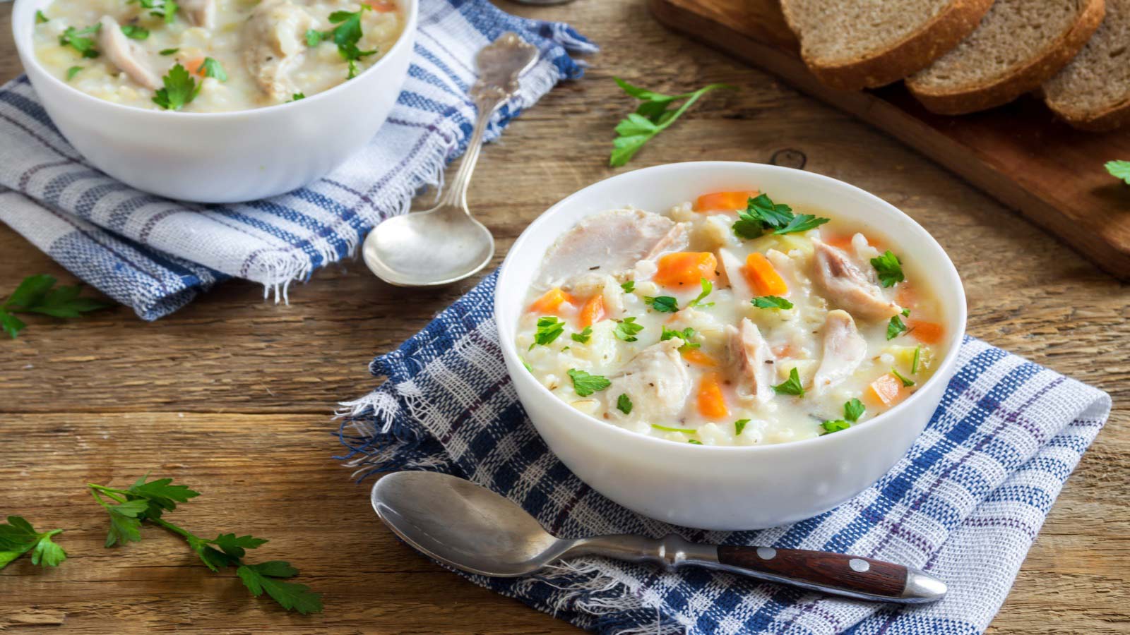 Chicken and Wild Rice Soup. Homemade fresh creamy soup with chicken, vegetables and wild rice in white bowl close up.