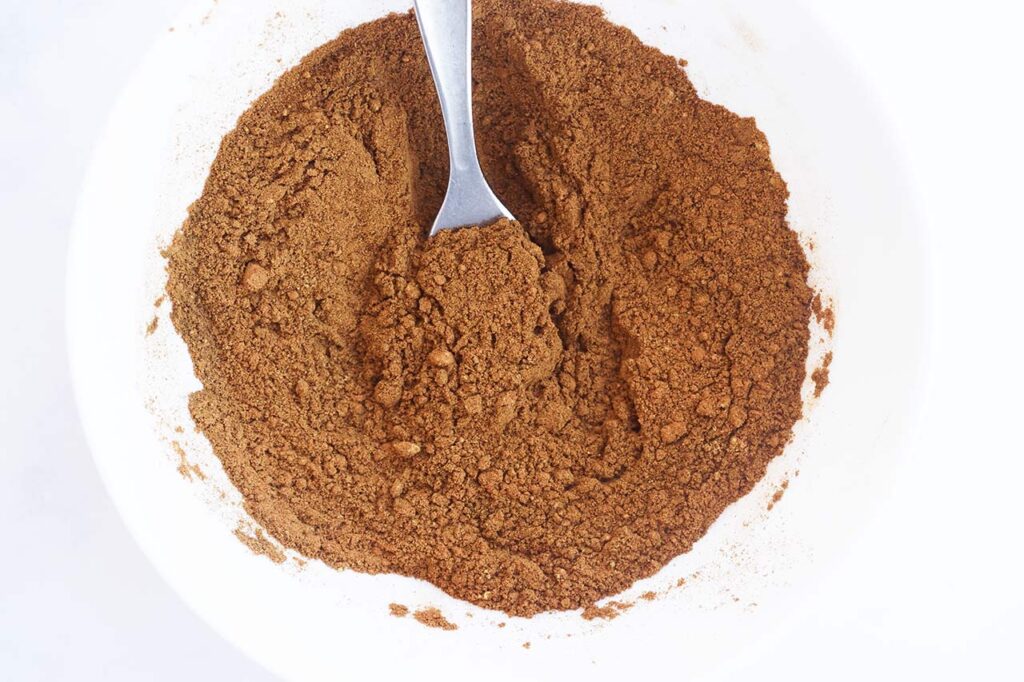 Mulling spices mixed together in a white mixing bowl. Overhead view.