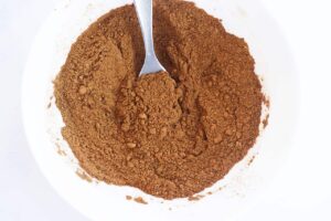 Mulling spices mixed together in a white mixing bowl. Overhead view.
