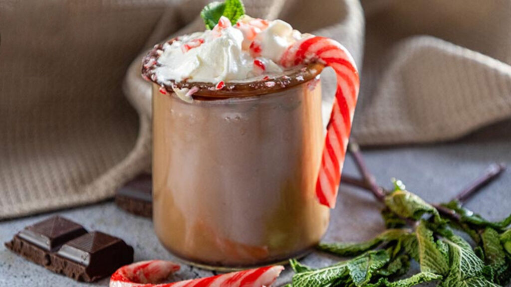 A finished cup of Peppermint Hot Chocolate in a glass mug.