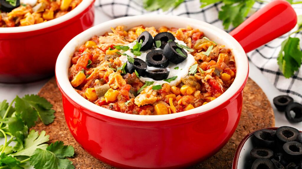 Side view of a crock full of Slow Cooker Tortilla Chicken Stew.