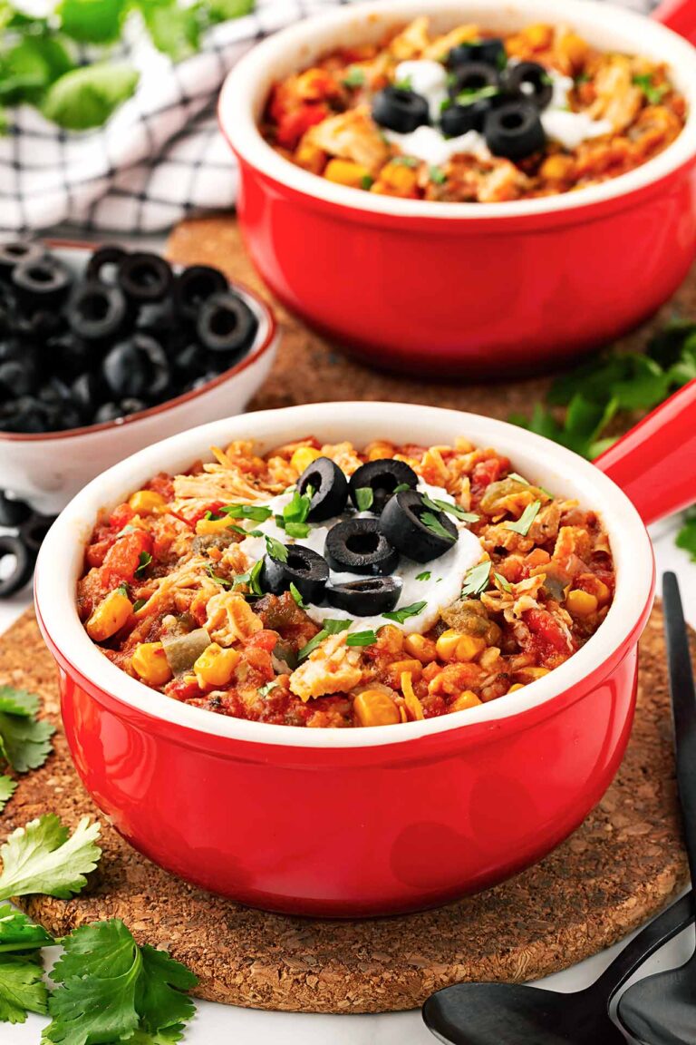 Two red crocks filled with Slow Cooker Tortilla Chicken Stew.