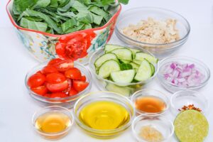 Chicken And Collard Greens Recipe ingredients in individual bowls.