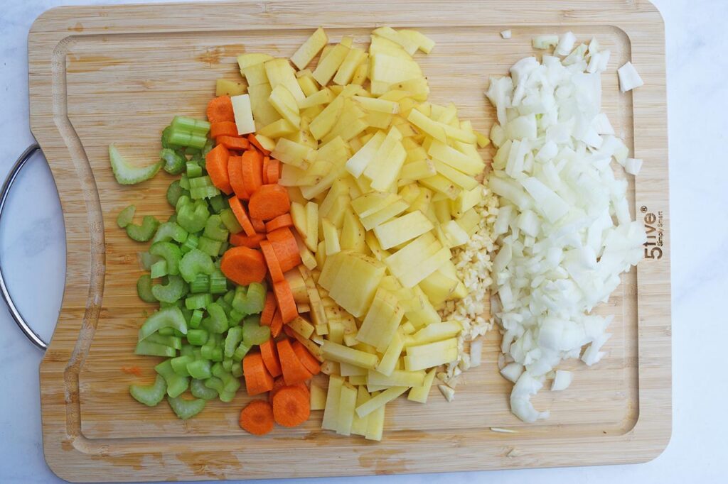 Chopped raw veggies on a cutting board.