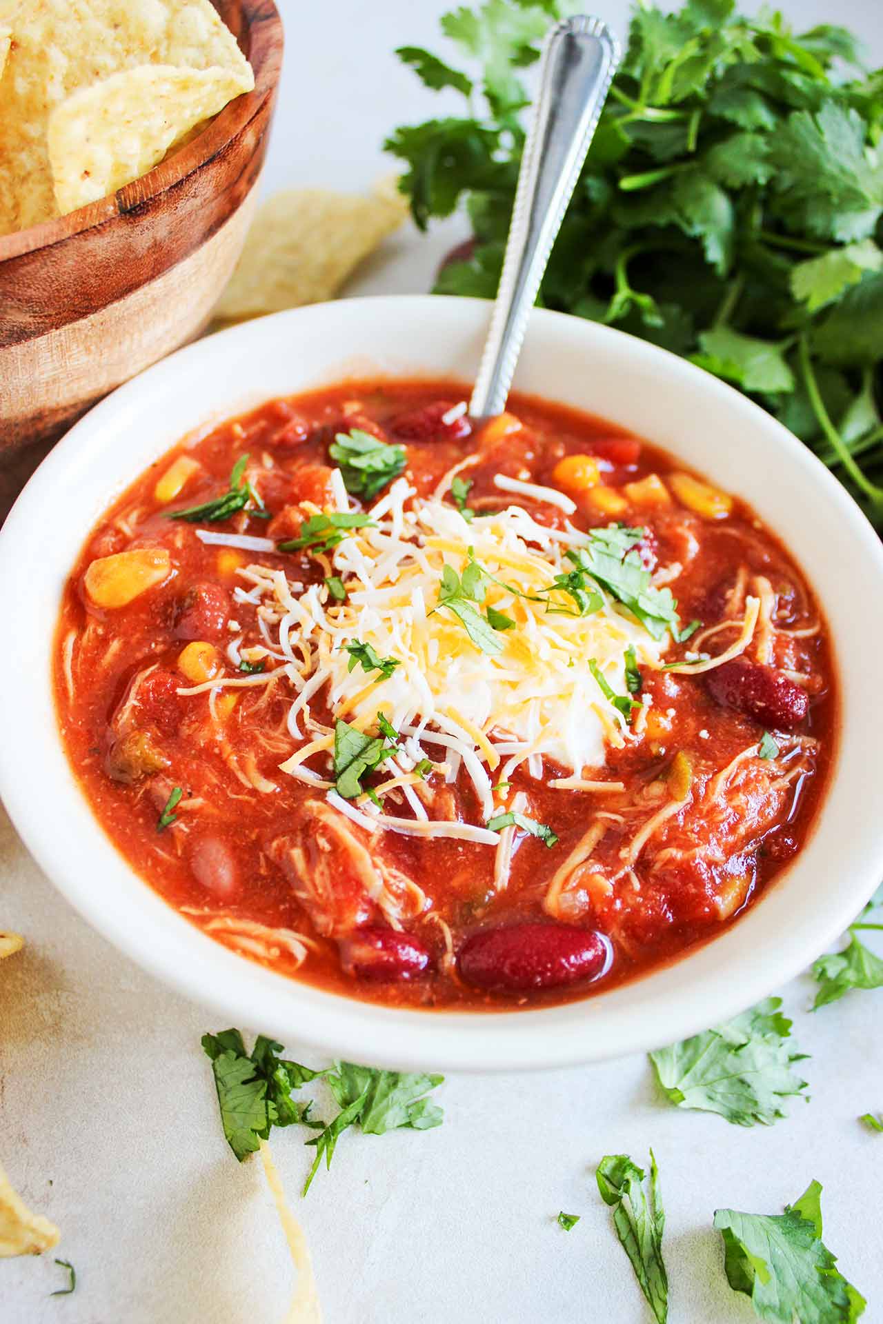 Overhead front view of a white bowl of Chicken Taco Chili.
