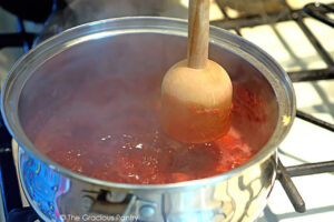 Mashing berries in a hot pot.