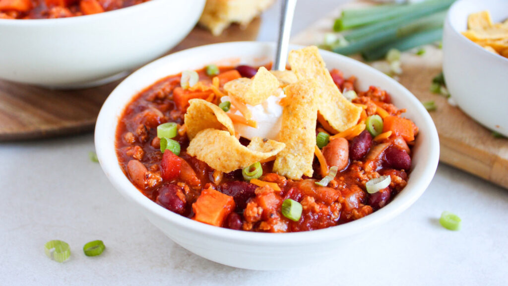 A white bowl filled with Classic Chicken Chili.