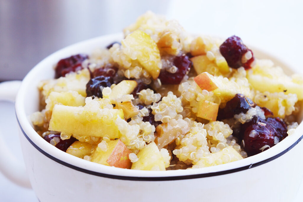 Cranberry Apple Quinoa Salad served in a white mug.