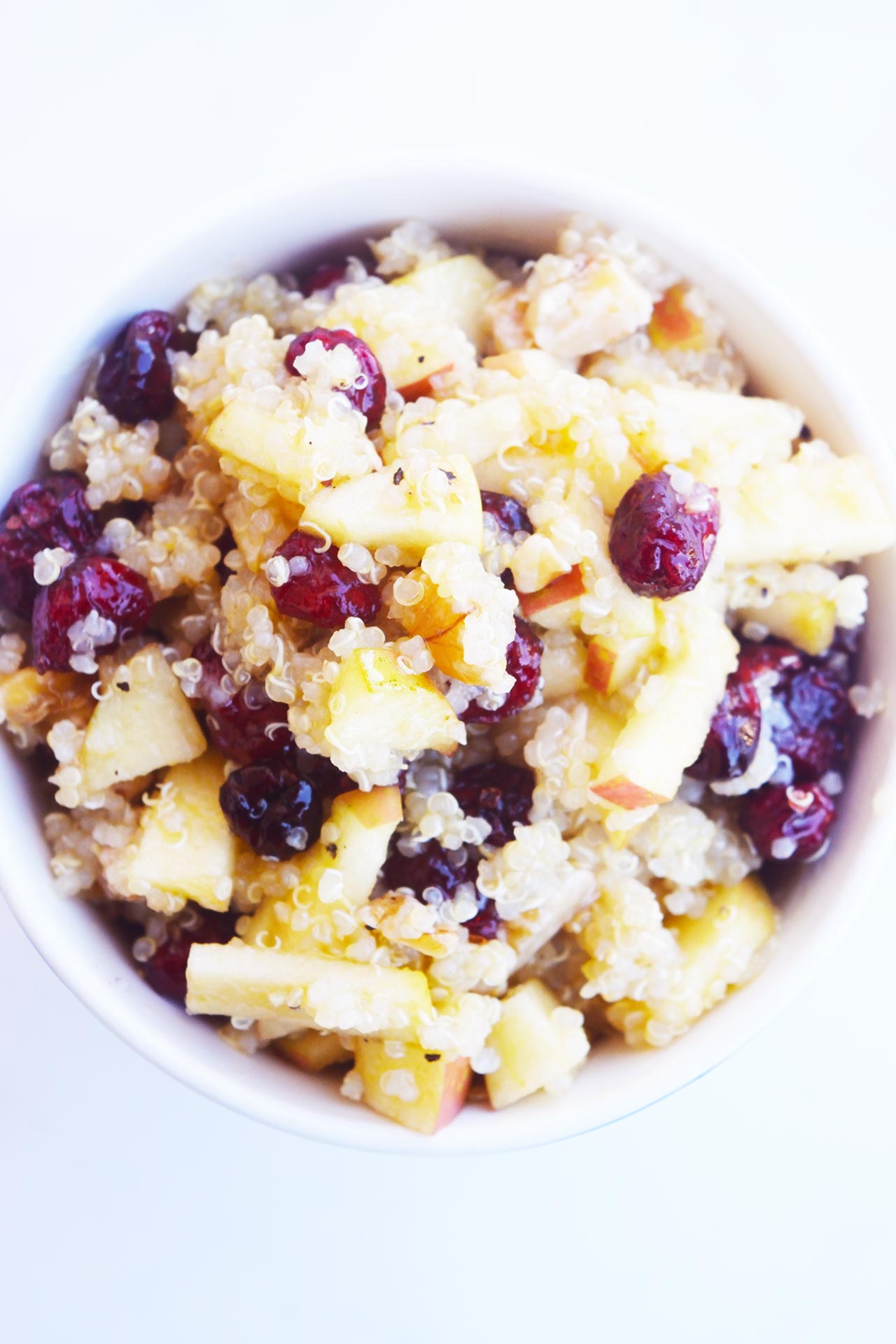 Overhead view of a white mug filled with Cranberry Apple Quinoa Salad.