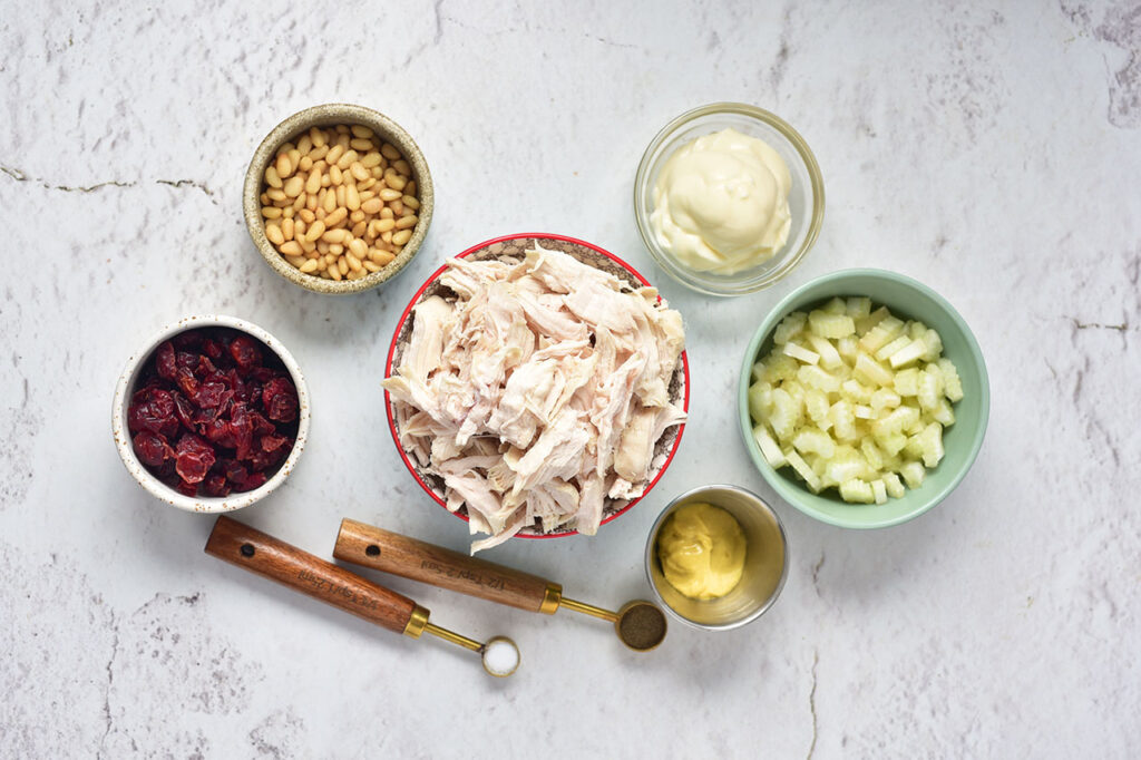 Ingredients for a Cranberry Chicken Salad in individual bowls.