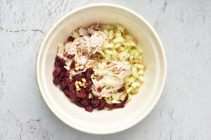 Ingredients for a Cranberry Chicken Salad in a mixing bowl.