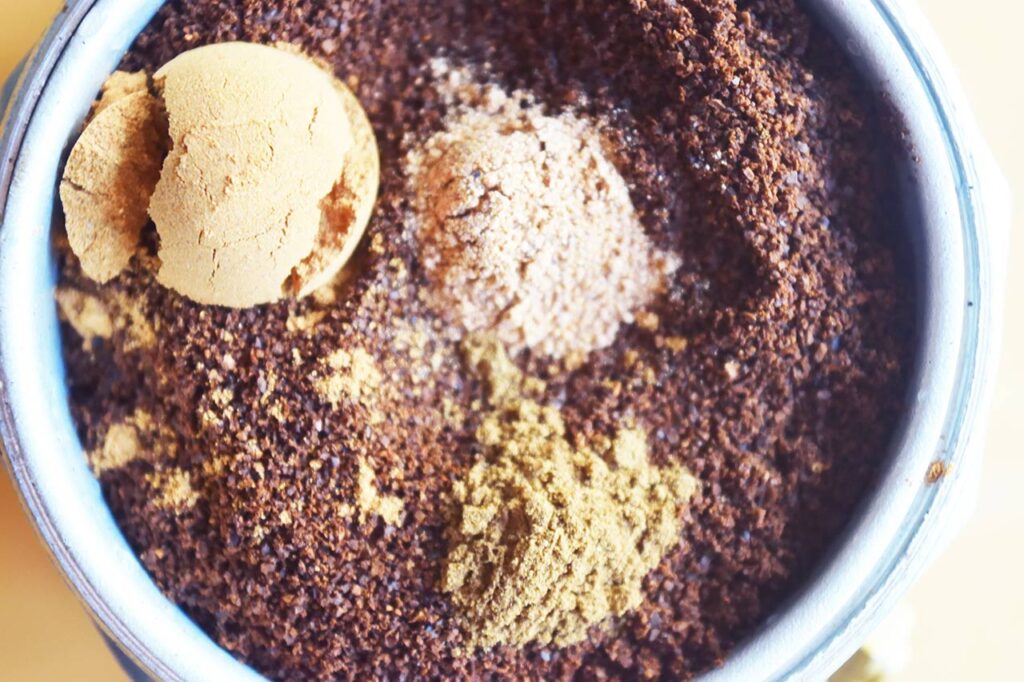 Spices added to ground coffee. Close up.