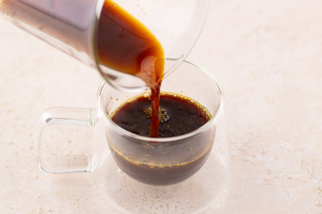 Pouring coffee into a mug.