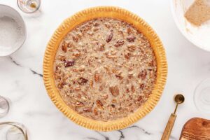 Pecan pie batter poured into a ready crust.